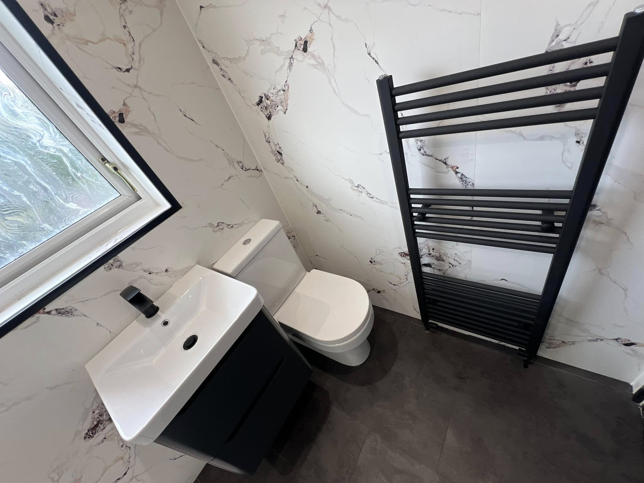 black radiator next to toilet and sink