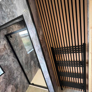 show wall panels next to acoustic wood black radiator