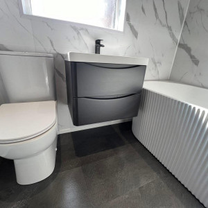 clean bathroom black drawers sink