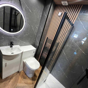 wood panel wall and ceiling hung mirror toilet